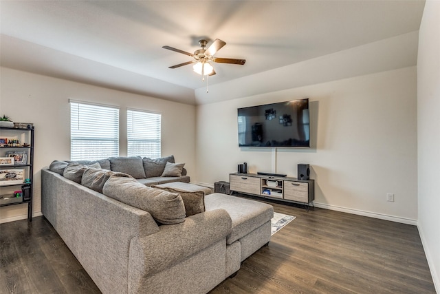 living room featuring dark wood-type flooring and ceiling fan