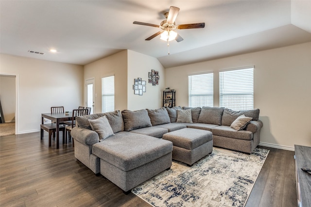 living room featuring ceiling fan, plenty of natural light, dark hardwood / wood-style floors, and vaulted ceiling