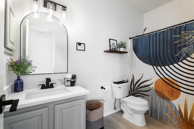 bathroom with a shower with shower curtain, vanity, toilet, and hardwood / wood-style floors