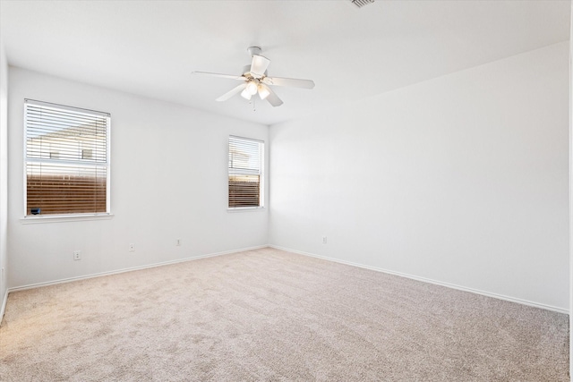 spare room featuring carpet floors and ceiling fan