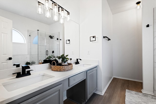 bathroom with vanity, hardwood / wood-style floors, and a shower with shower door