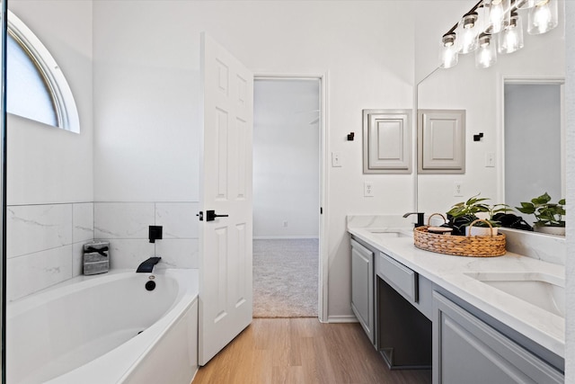 bathroom with vanity, a bathtub, and hardwood / wood-style flooring