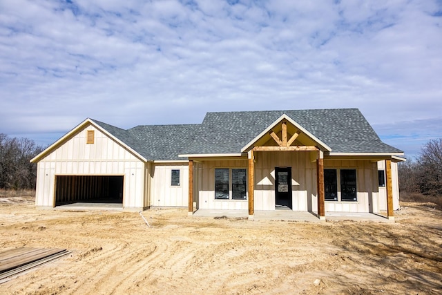 view of front of property featuring a garage and a porch