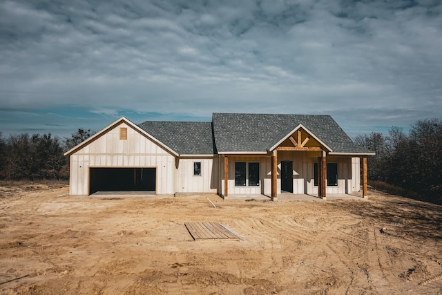 view of front of property with a porch and a garage