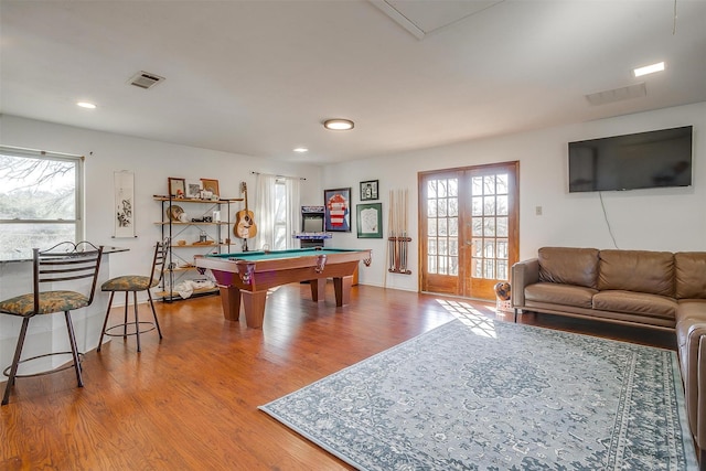 recreation room featuring wood-type flooring, billiards, french doors, and a healthy amount of sunlight