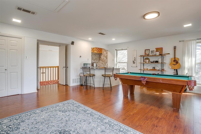 recreation room with bar, pool table, wood-type flooring, and plenty of natural light