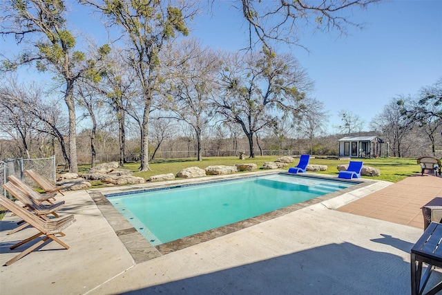 view of swimming pool featuring a yard and a patio