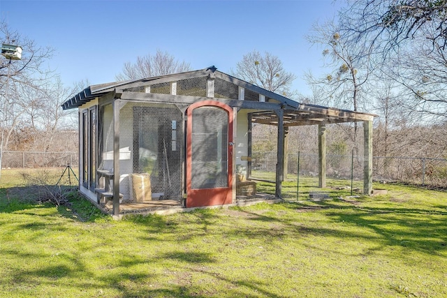 view of outbuilding featuring a lawn