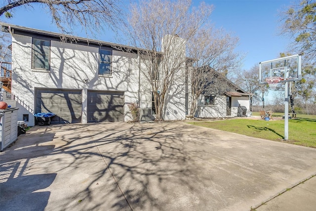 exterior space with a garage and a yard