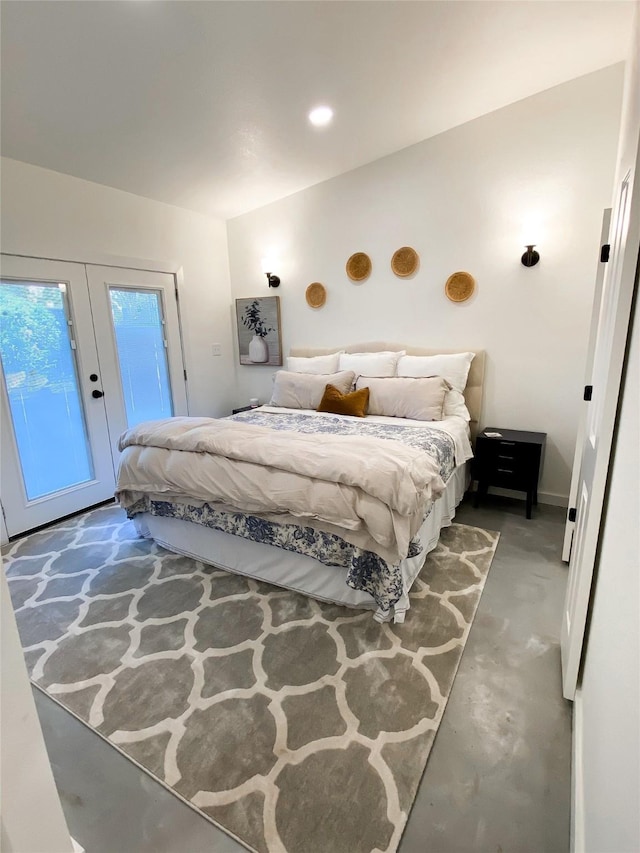 bedroom featuring access to exterior and concrete floors