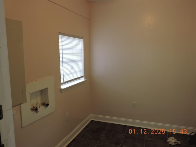 laundry room with dark tile patterned flooring and hookup for a washing machine