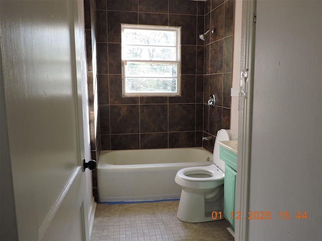 full bathroom featuring vanity, tile patterned flooring, tiled shower / bath combo, and toilet