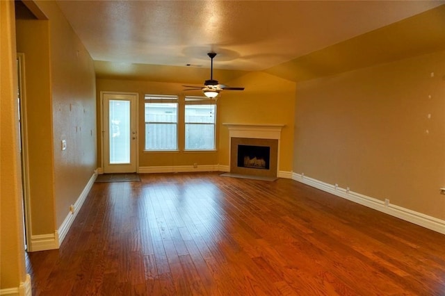 unfurnished living room featuring wood-type flooring, lofted ceiling, and ceiling fan