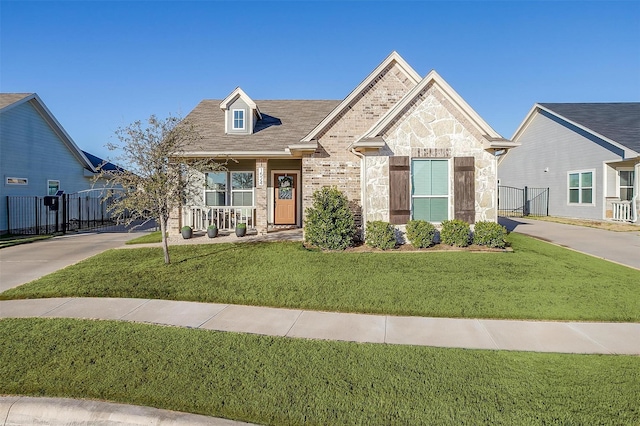 view of front of home with a front yard and covered porch