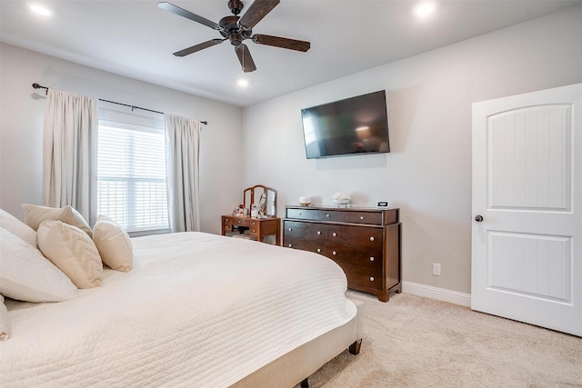 bedroom featuring light carpet and ceiling fan