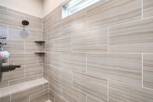 bathroom with a tile shower