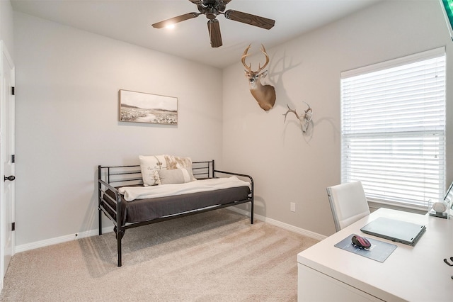 bedroom featuring ceiling fan and light carpet