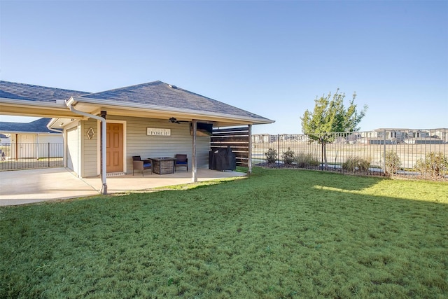 back of property with a yard and a patio