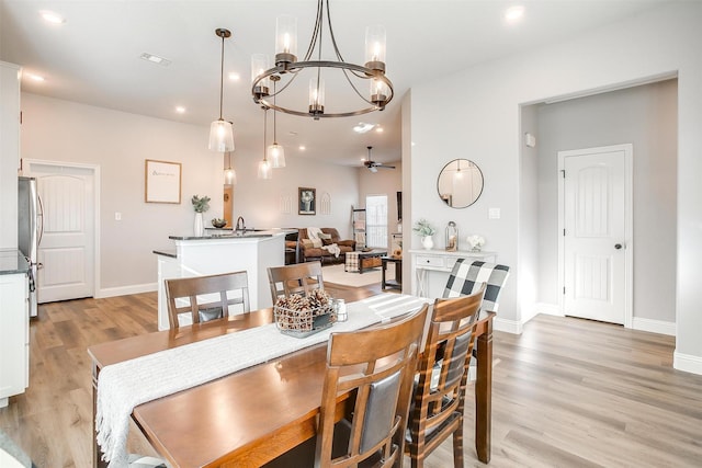 dining area with ceiling fan and light hardwood / wood-style floors