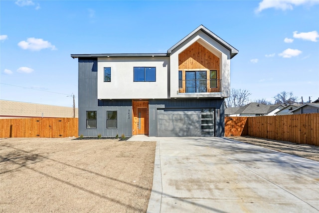 contemporary home with a garage and a balcony