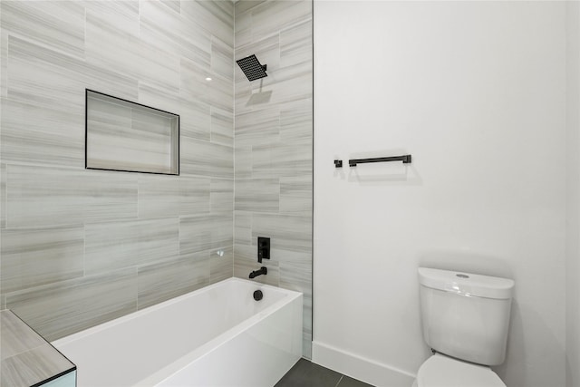 bathroom featuring tiled shower / bath and toilet