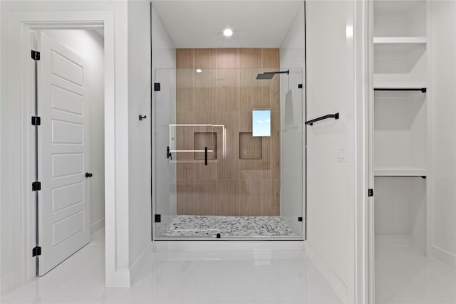 bathroom with a shower with door