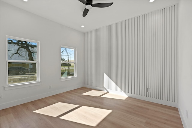 spare room with ceiling fan and light wood-type flooring