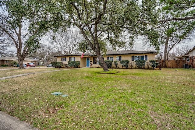 single story home featuring cooling unit and a front lawn