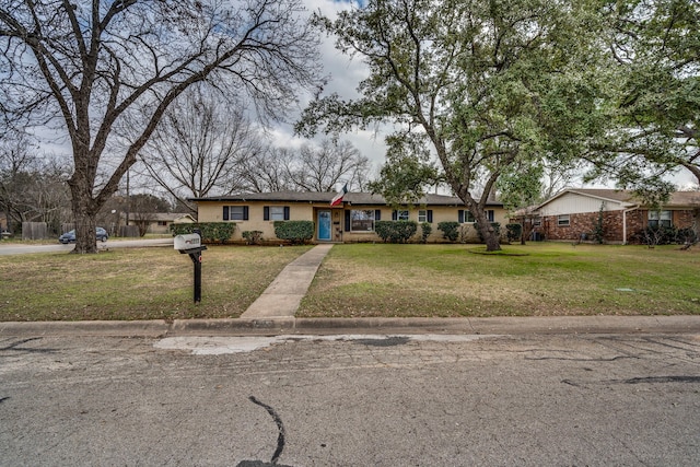 ranch-style home with a front yard