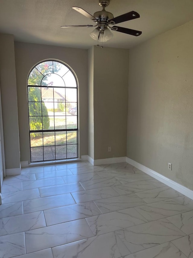 unfurnished room featuring a textured ceiling and ceiling fan