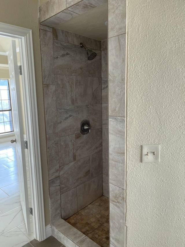 bathroom with a tile shower