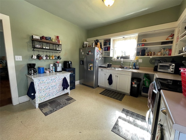 kitchen with sink, stainless steel appliances, and white cabinets