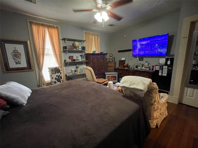 bedroom featuring ceiling fan and dark hardwood / wood-style floors