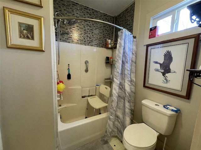 bathroom featuring shower / bathtub combination with curtain and toilet