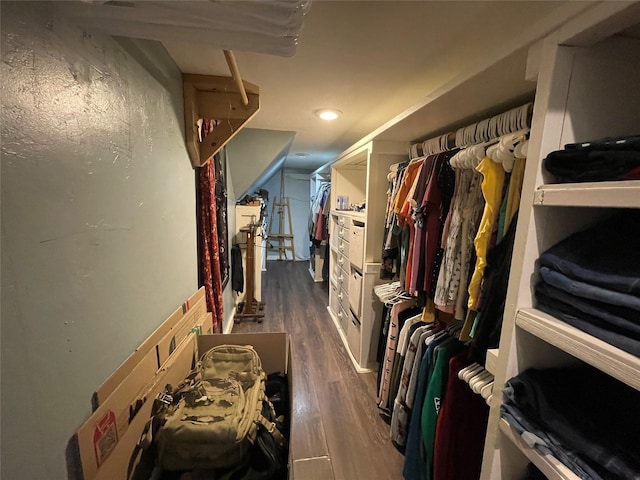 walk in closet with dark wood-type flooring