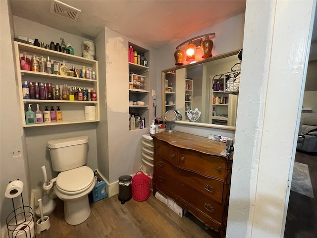 bathroom with hardwood / wood-style floors and toilet