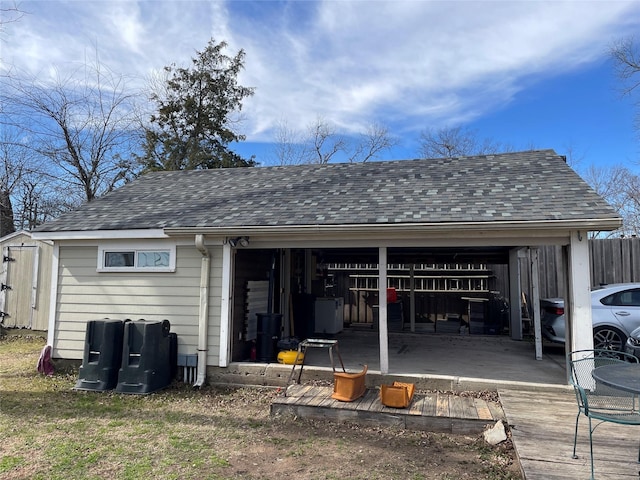 rear view of property with an outbuilding and a garage
