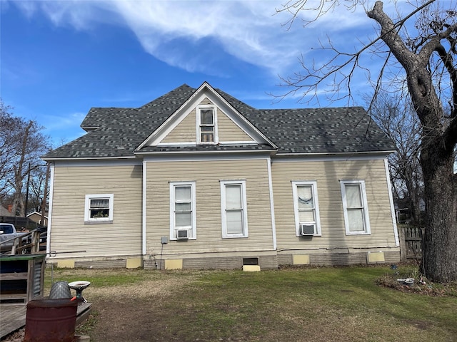 rear view of property featuring a yard and cooling unit