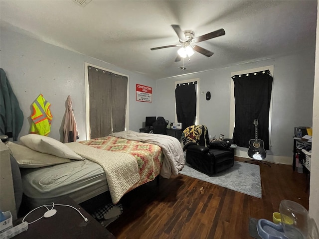 bedroom featuring dark hardwood / wood-style floors and ceiling fan