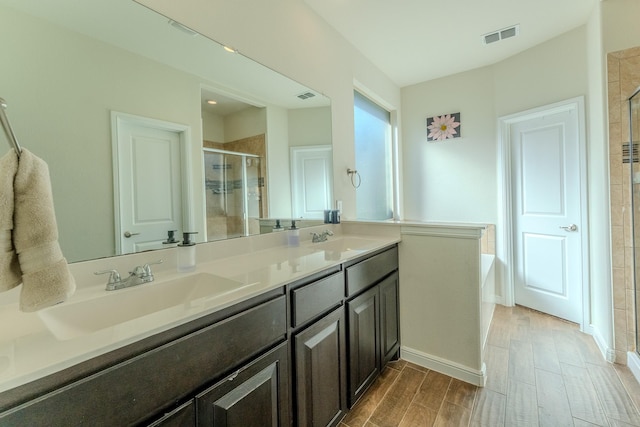 bathroom featuring vanity and separate shower and tub