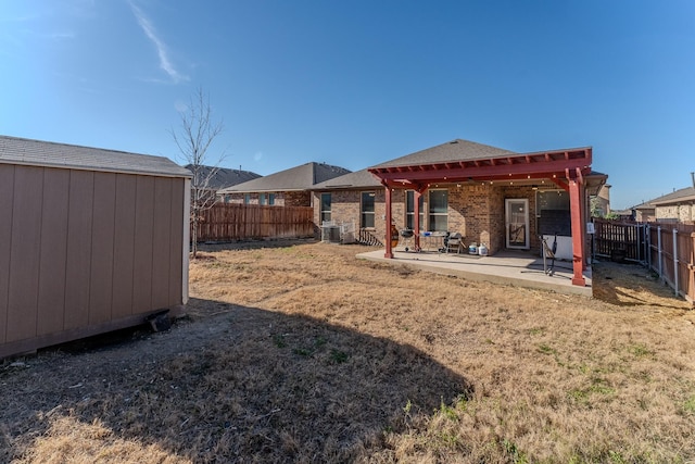 view of yard with a storage shed and a patio area