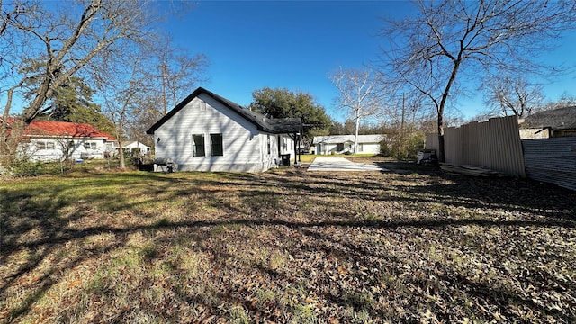 rear view of property with a lawn