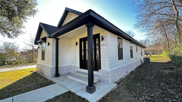 view of side of property featuring central AC