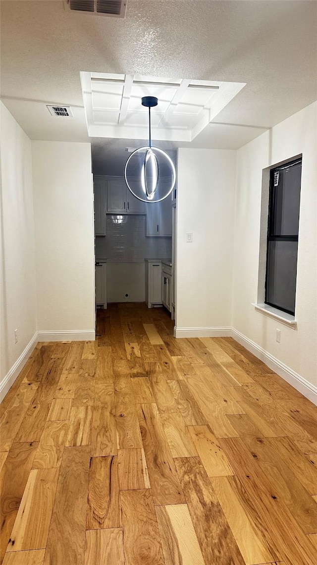 interior space featuring light hardwood / wood-style flooring and a textured ceiling