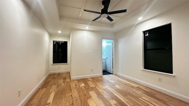 unfurnished room with coffered ceiling, light hardwood / wood-style floors, and ceiling fan