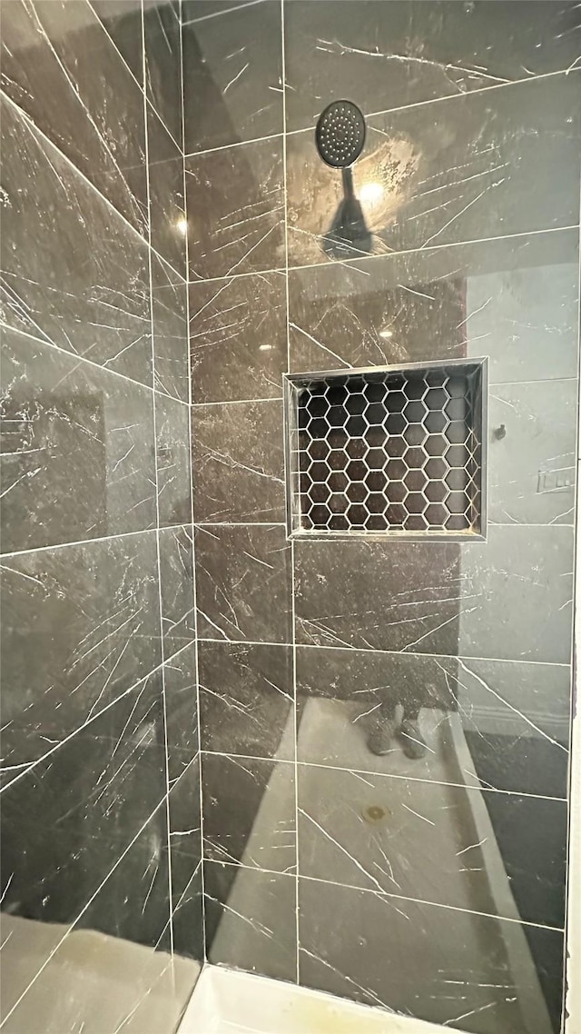 bathroom with a tile shower