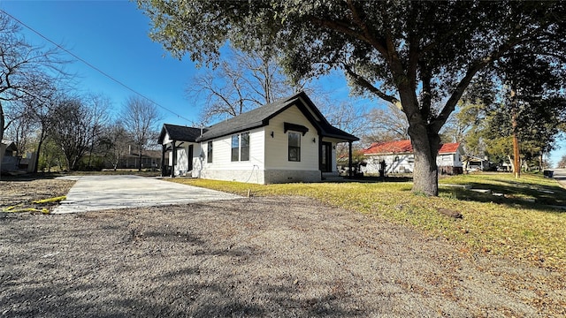 view of side of home with a lawn