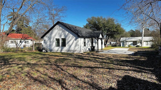 view of side of home featuring a yard