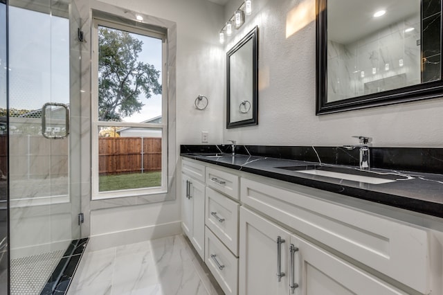 bathroom with walk in shower and vanity