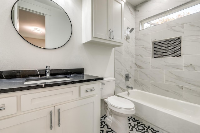 full bathroom with vanity, toilet, and tiled shower / bath